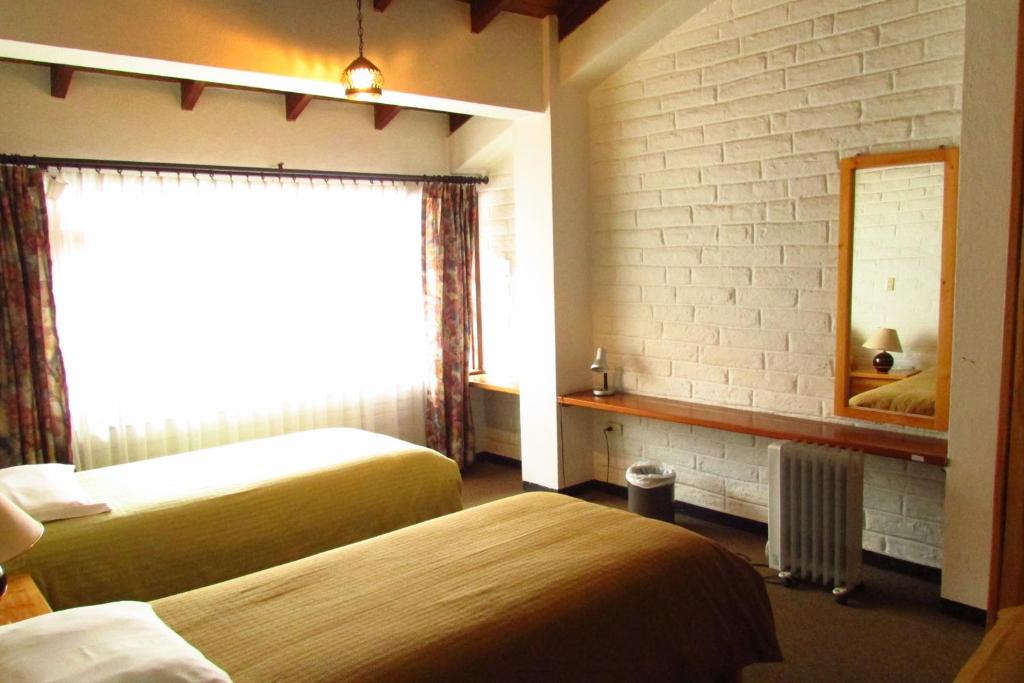 Postel nebo postele na pokoji v ubytování Apartamentos Los Quipus