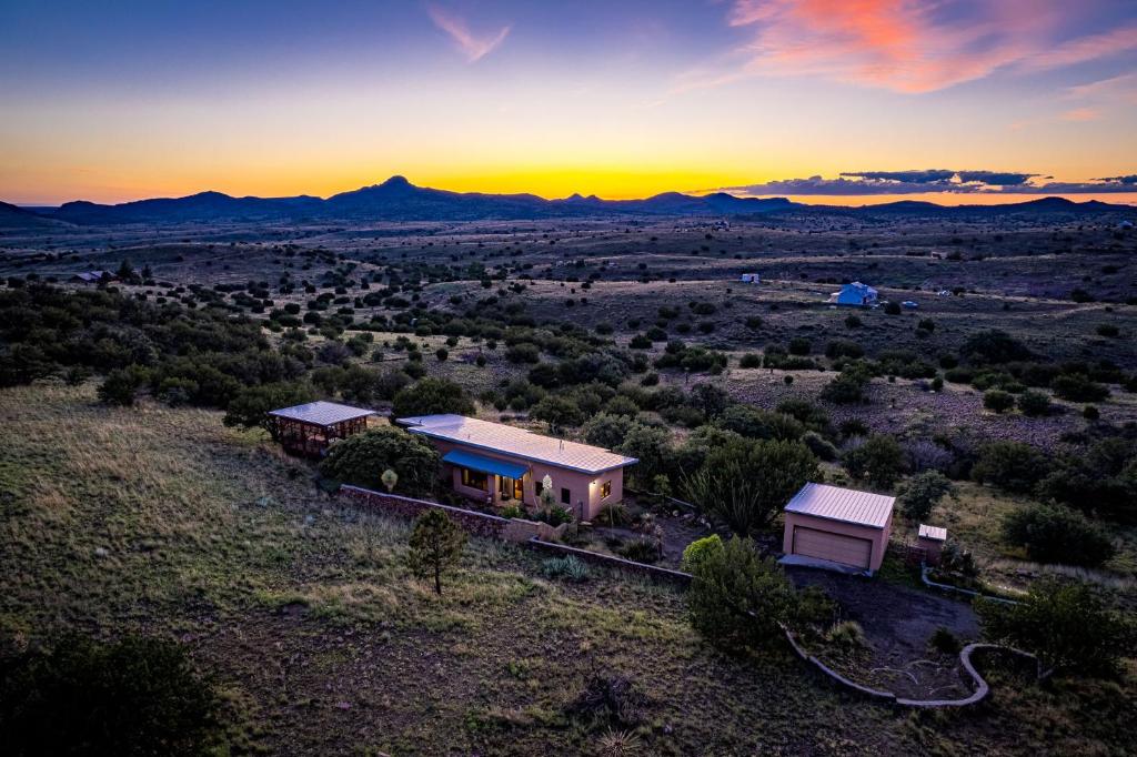 an aerial view of a house with the sunset in the background at Casa de Luna in Alpine