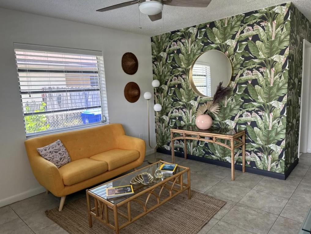 a living room with a couch and a mirror at Miami's Cozy Tropical Getaway in Miami