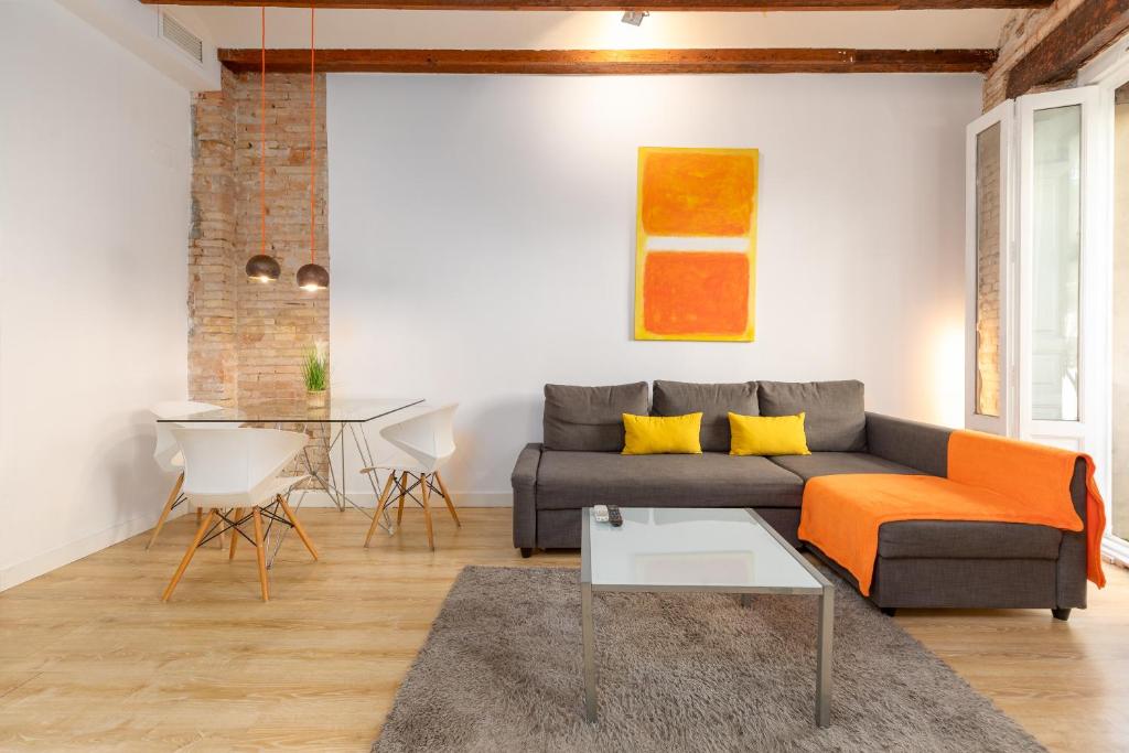 a living room with a couch and a table at Baron Suites Reina in Valencia