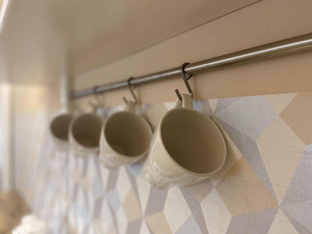 a row of cups hanging on a wall at Holiday home in Heviz - Balaton 44882 in Hévíz