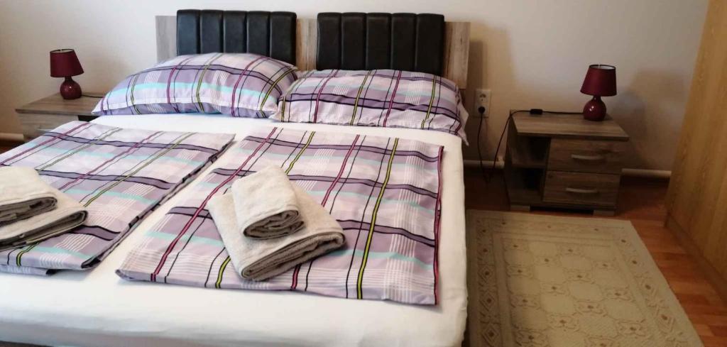 a bed with two pillows and a blanket on it at Apartment in Keszthely - Balaton 44884 in Keszthely