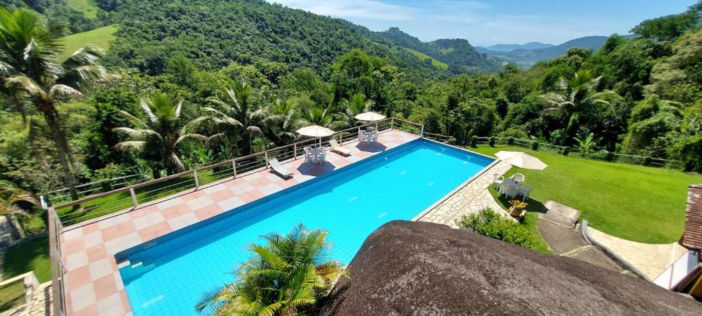 an overhead view of a swimming pool with mountains in the background at Pousada La Dolce Vita Paraty in Paraty