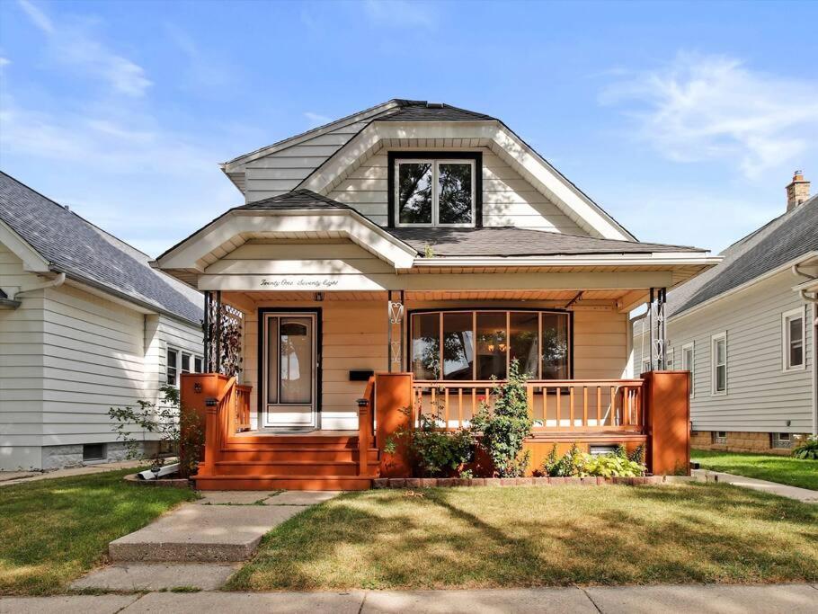 a house with a wooden porch and a house at Convenient 5 bedroomMetro Milwaukee Brewers! in West Allis