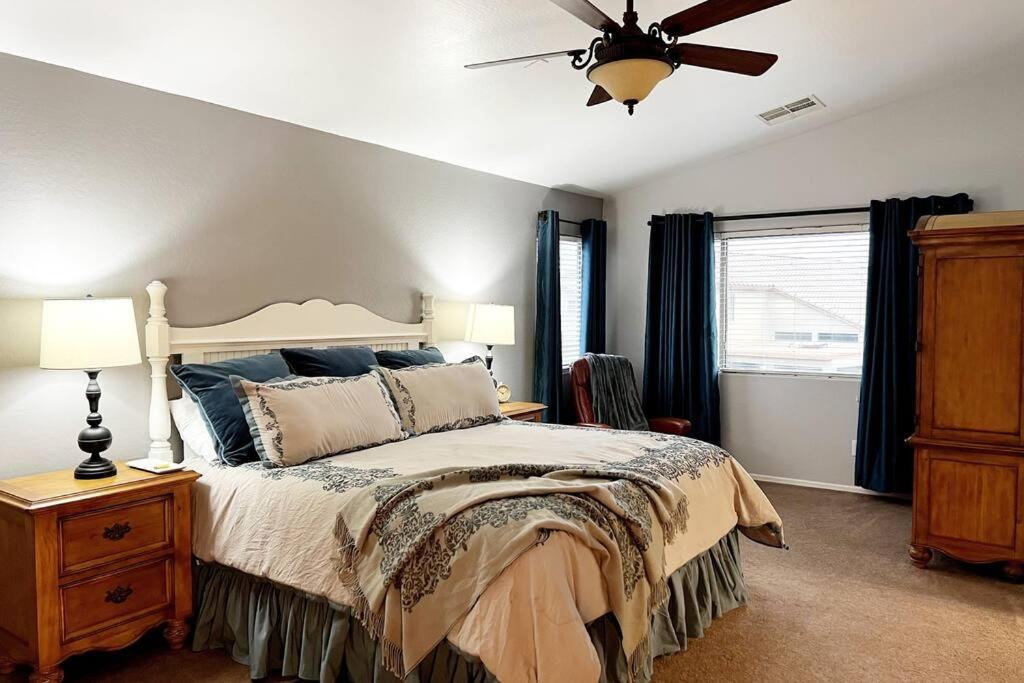 a bedroom with a bed and a ceiling fan at La Posada de Lucy, LLC in Phoenix