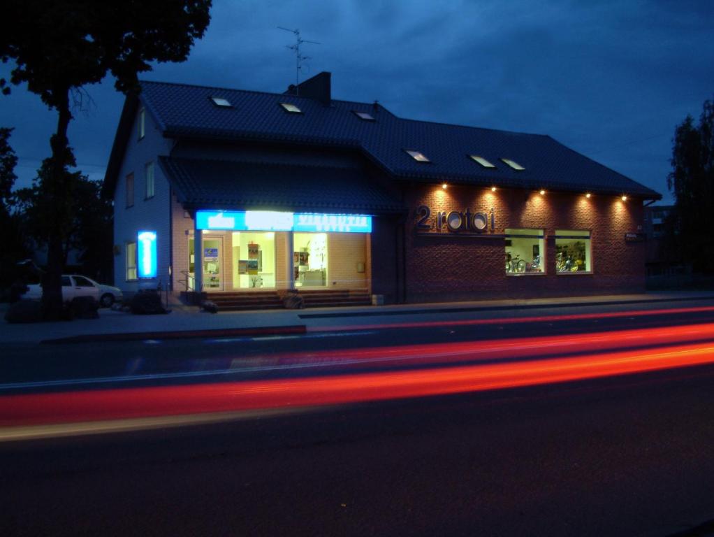 a building with lights on the side of a street at Eiva in Marijampolė