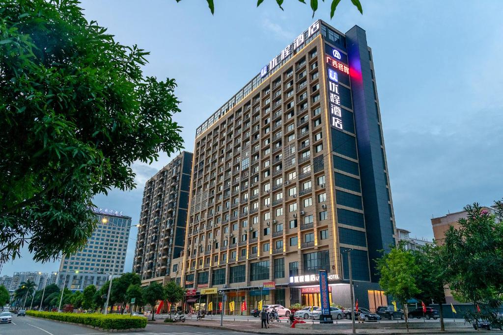 a tall building with a sign on the side of it at Unitour Hotel, Nanning Xianhu in Nanning