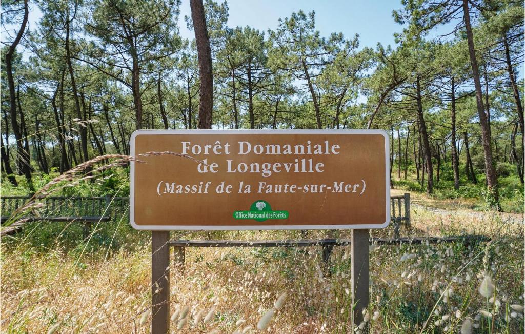 a sign in front of a forest with trees at 2 Bedroom Beautiful Home In La Faute-sur-mer in La Faute-sur-Mer