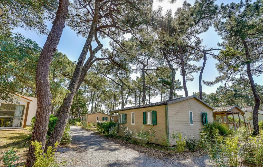 a house in the woods with trees at 2 Bedroom Beautiful Home In La Faute-sur-mer in La Faute-sur-Mer