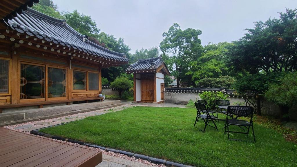 a yard with chairs and a table and a building at Ever Healing House in Namugil