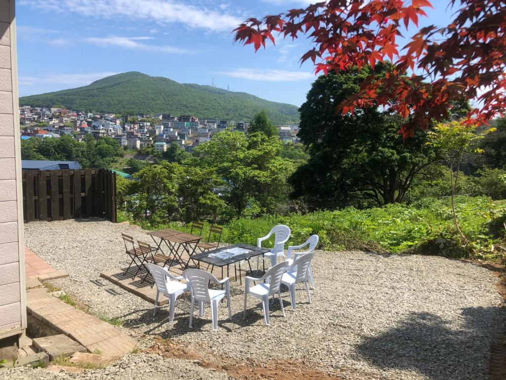 una mesa y sillas con vistas a la ciudad en Cool-Cottage Otaru OTAMOI, en Otaru