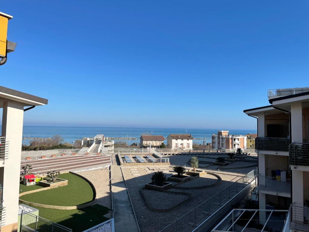 a view of the ocean from the balcony of a building at Residence Verde Mare in Massignano