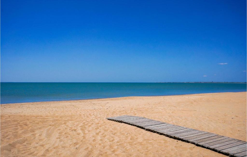 a wooden plank in the sand on a beach at 2 Bedroom Beautiful Home In La Faute-sur-mer in La Faute-sur-Mer