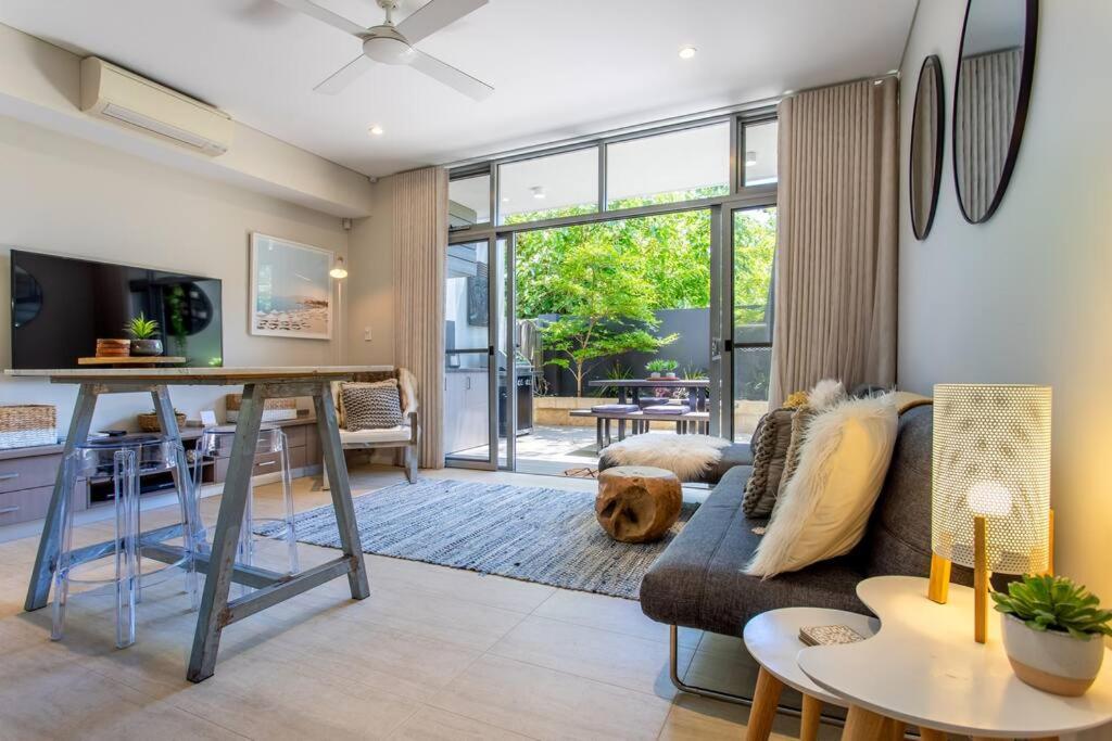 a living room with a couch and a dog laying on a rug at Dunn Bay Apartment 4 I Private Properties in Dunsborough