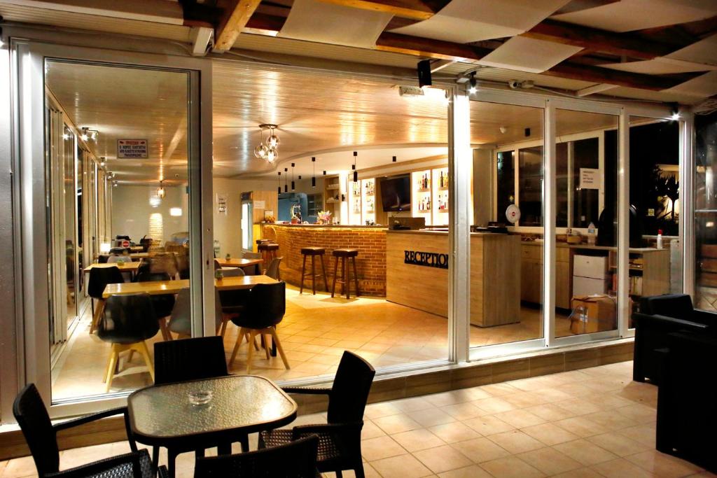 a kitchen and dining room with tables and chairs at Akis Studios Alykes in Alykes