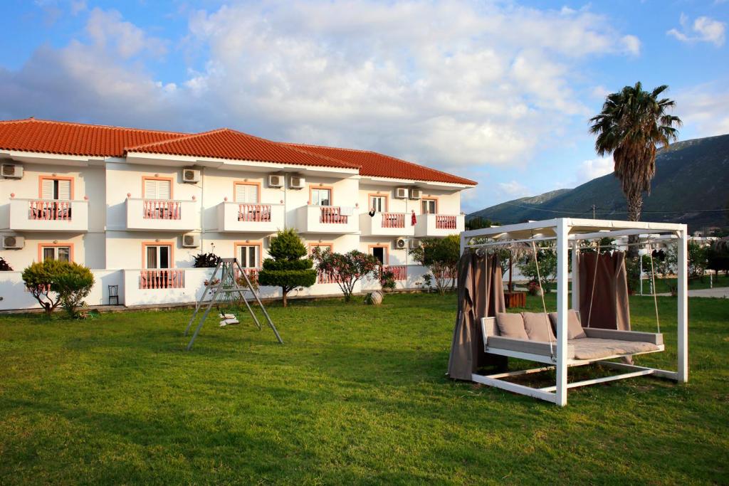 a hotel with a gazebo in front of a building at Akis Studios Alykes in Alykes