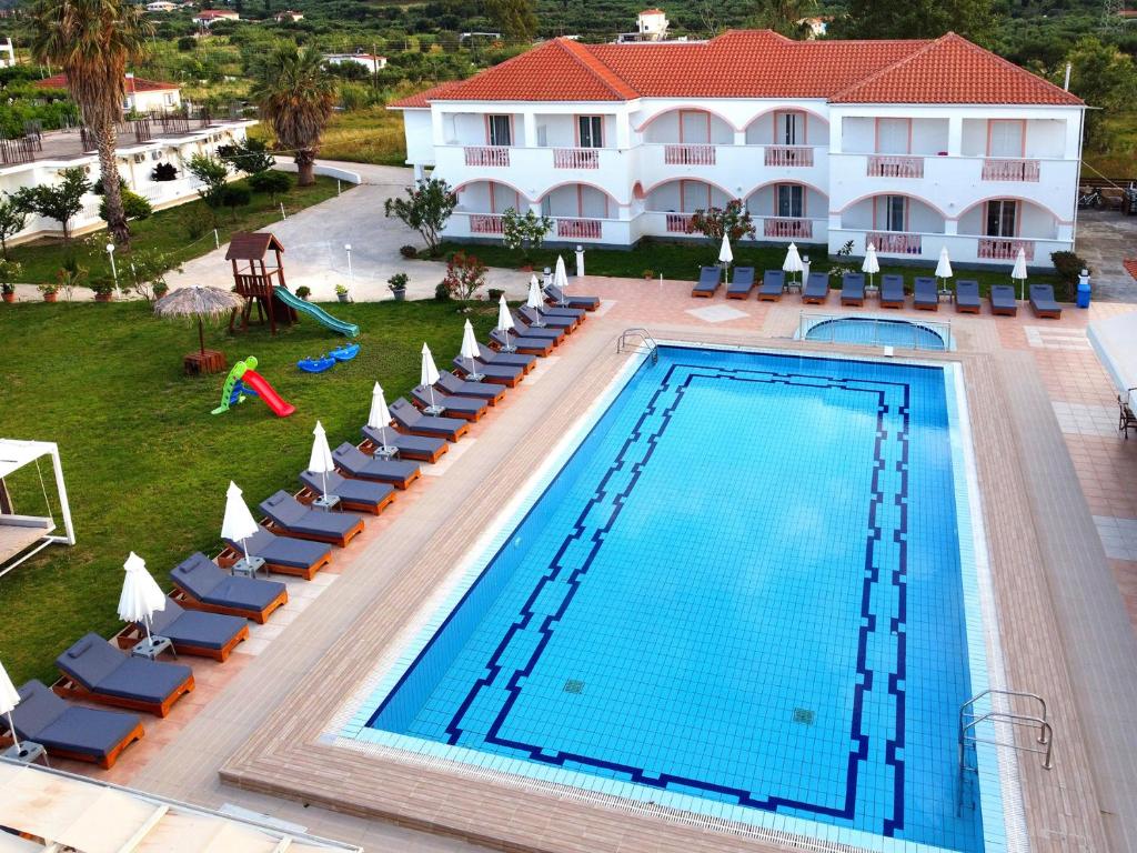 an overhead view of a swimming pool with chairs and a resort at Akis Studios Alykes in Alykes