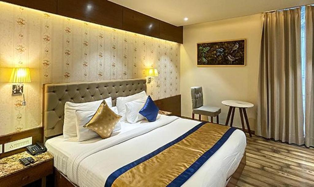 a hotel room with a large bed and a desk at FabHotel Prime The Wish in Jaipur