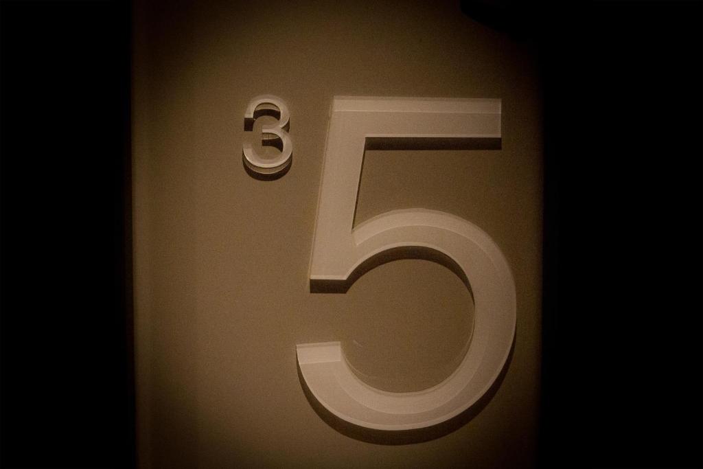 a number on a wall with the number six at La Regence in Courbevoie