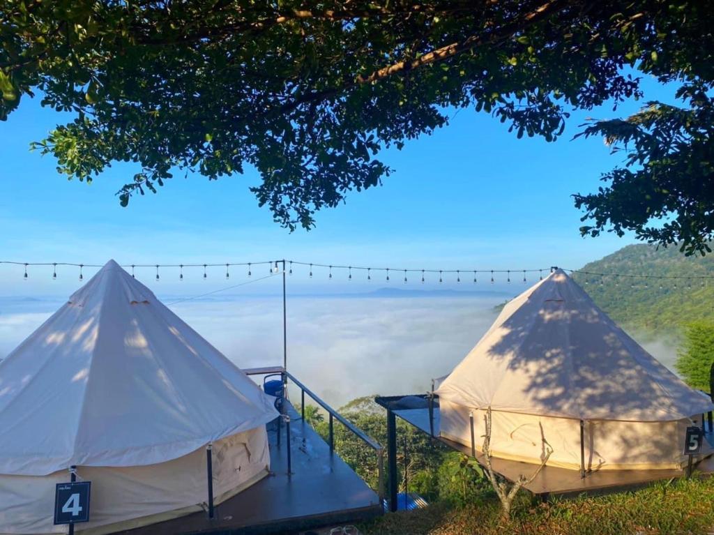 a couple of tents with a view of the mountains at Heaven Khaokho (เฮฟเว่น) in Khao Kho