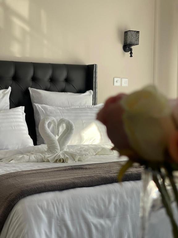a bed with two white swans on it at The Ace Hotel in Lusaka