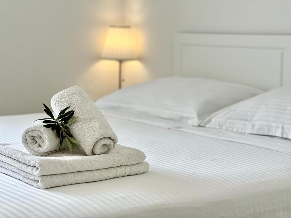 a pair of towels sitting on a bed at Apartments Juric in Mimice