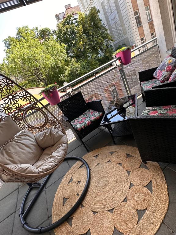 balkon z rattanowym krzesłem i stołem w obiekcie Vienna Citycenter+Terrace+Parking w Wiedniu
