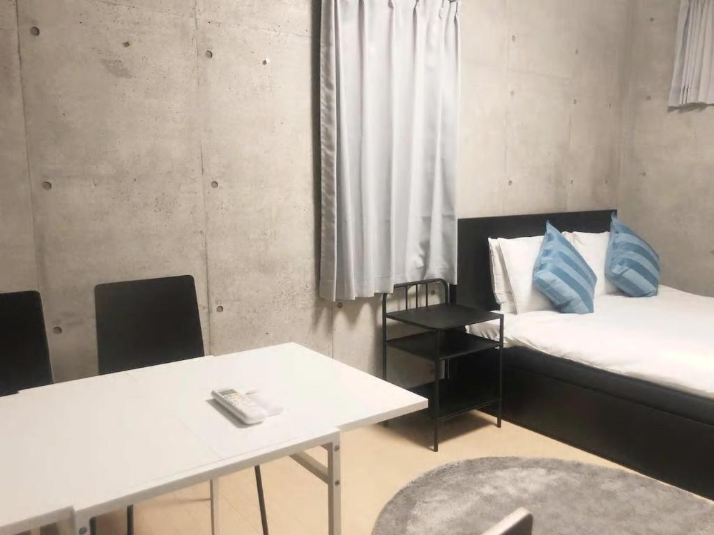 Postel nebo postele na pokoji v ubytování Laffitte Tokyo