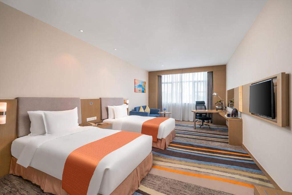 TV a/nebo společenská místnost v ubytování Guangzhou Baiyun Airport Rejoice by Argyle Hotel Rehe Metro Exit B --Free shuttle bus is provided during the 137th Canton Fair