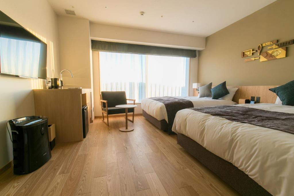 Postel nebo postele na pokoji v ubytování Spa & Hotel Suishun Matsuiyamate
