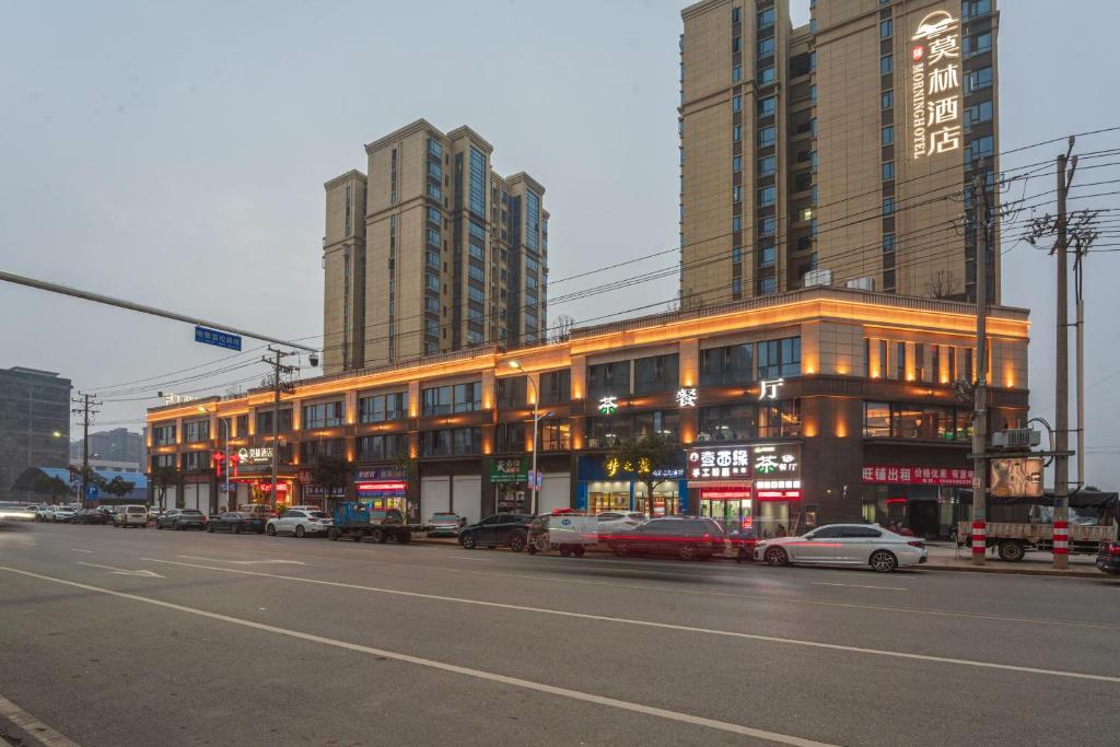 a building on a street with cars parked in front of it at Morning Hotel, Changsha Liuyang Yongan in Gutang