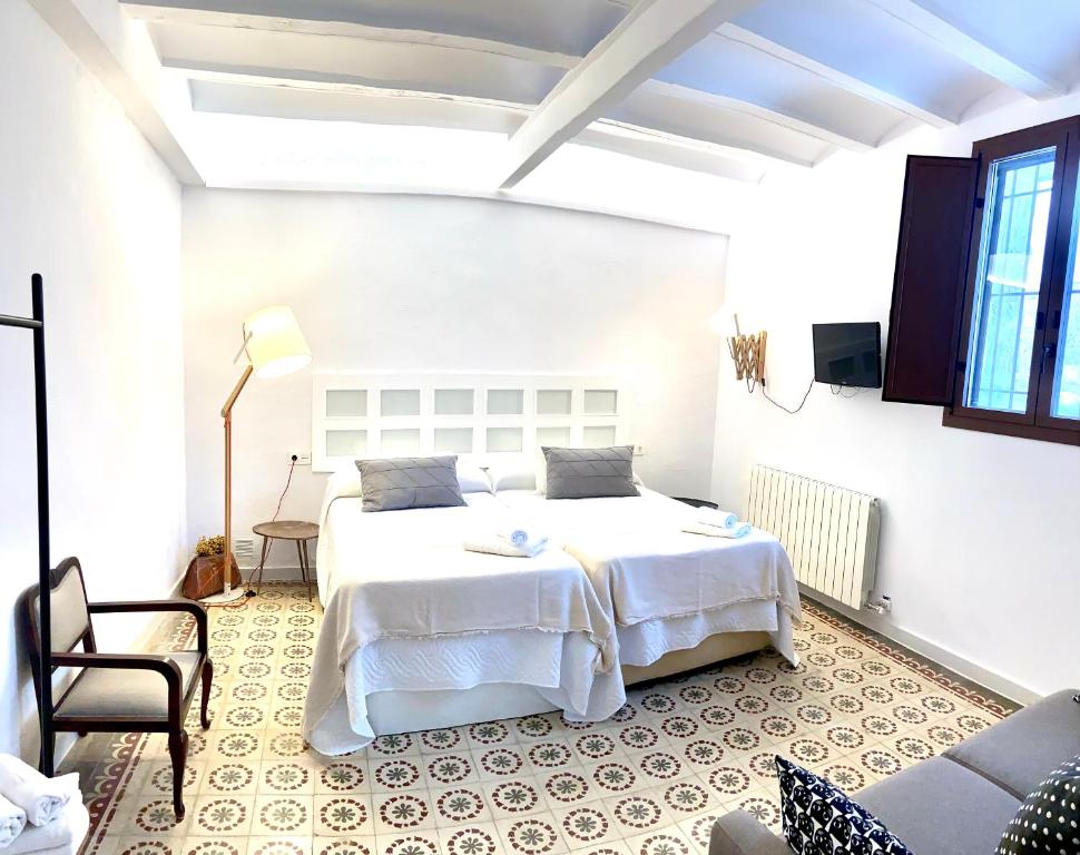 - une chambre avec un grand lit blanc dans l'établissement Casa Rural El Americano y disfruta de lo natural, à Albentosa