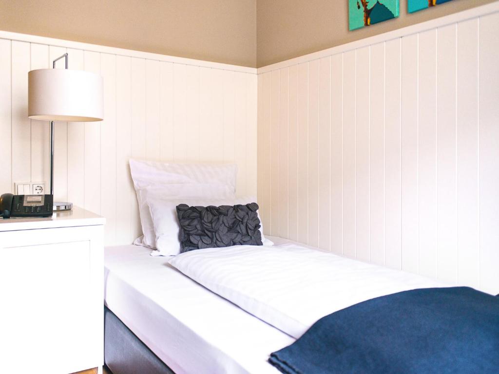 Cama ou camas em um quarto em Hotel Victoria