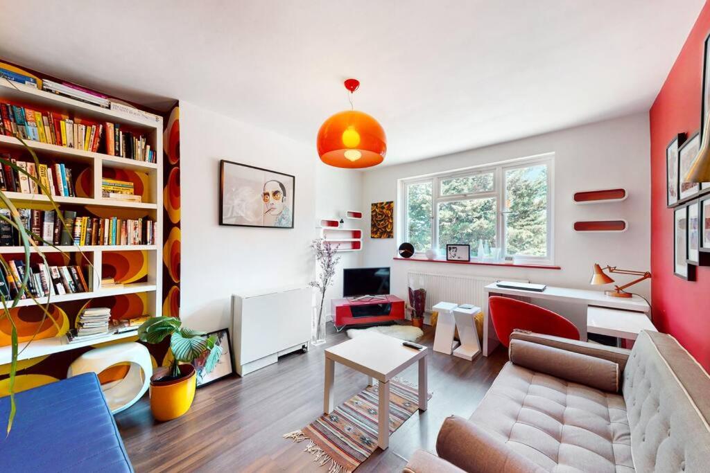 a living room with a couch and a table at Modernistic 2 BR maisonette in Kingsbury in Colindale