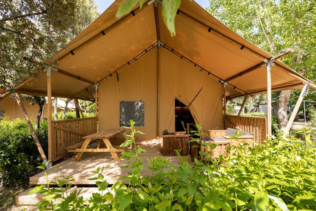 Camping Campo dei Fiori - Glamping4all في فادا: خيمة كبيرة فيها طاولة نزهة