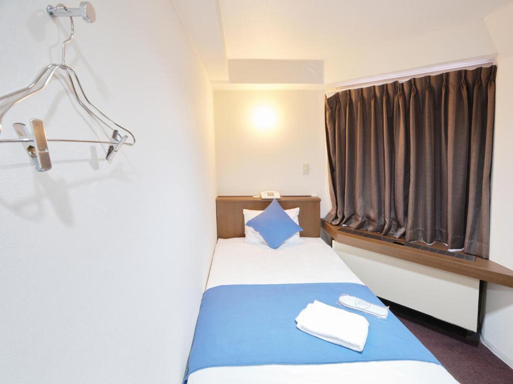 Postel nebo postele na pokoji v ubytování Pod Select Hotel Shinjuku