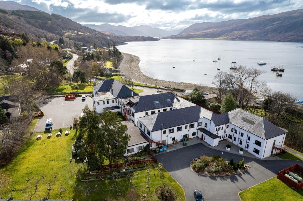 an aerial view of a house next to a body of water at The Royal Hotel in Ullapool
