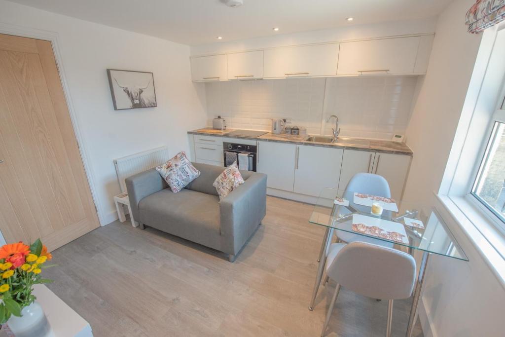 a living room with a couch and a table at Modern Apartment in Town Centre Skipton in Skipton