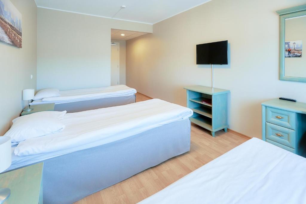 Postel nebo postele na pokoji v ubytování Hotel Dzingel
