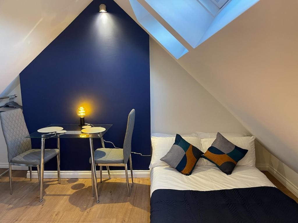 a bedroom with a bed and a table and chairs at Loft Studio, Excellent Central City Location in Cambridge