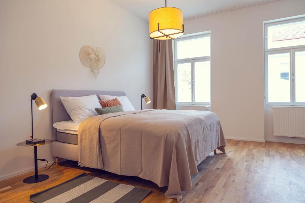 Hotel The 77 BERTA, a white bedroom with a bed and two windows at The 77 BERTA in Vienna