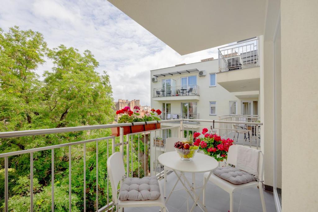 a balcony with a white table and chairs at FEEL HOME Superior-FREE PARKING-BALCONY-AC-Elevator in Budapest