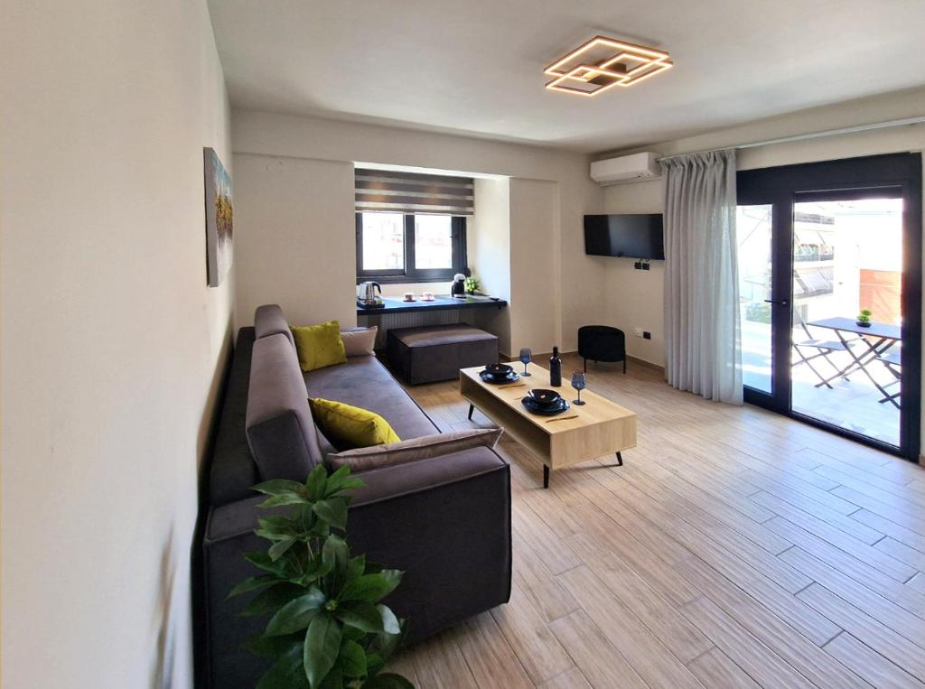 a living room with a couch and a table at Volos Terra Deluxe Residences in Volos