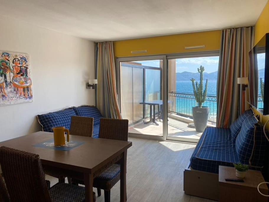 un salon avec un canapé et une table avec vue dans l'établissement VUE MER 4 pers. 50 m plage Clim Piscine Parking HH FERNANDE, à Cannes