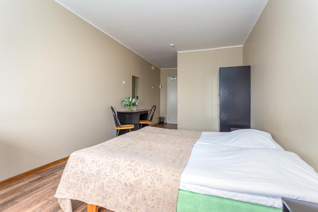 Postel nebo postele na pokoji v ubytování Hotel Dzingel