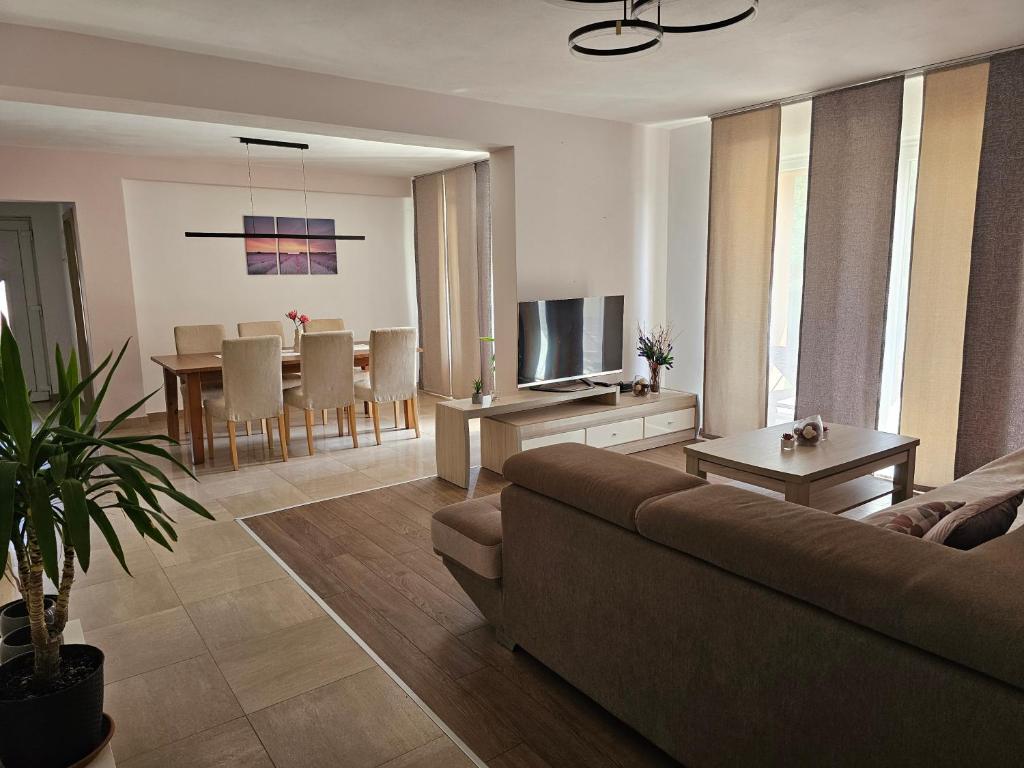 a living room with a couch and a dining room at Premium Apartments Tade Funtana in Funtana