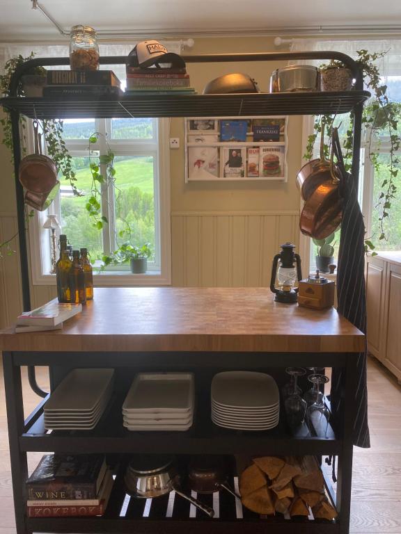 a kitchen with a counter with plates and pans at Heidal Gjestgiveri AS in Nedre Heidal