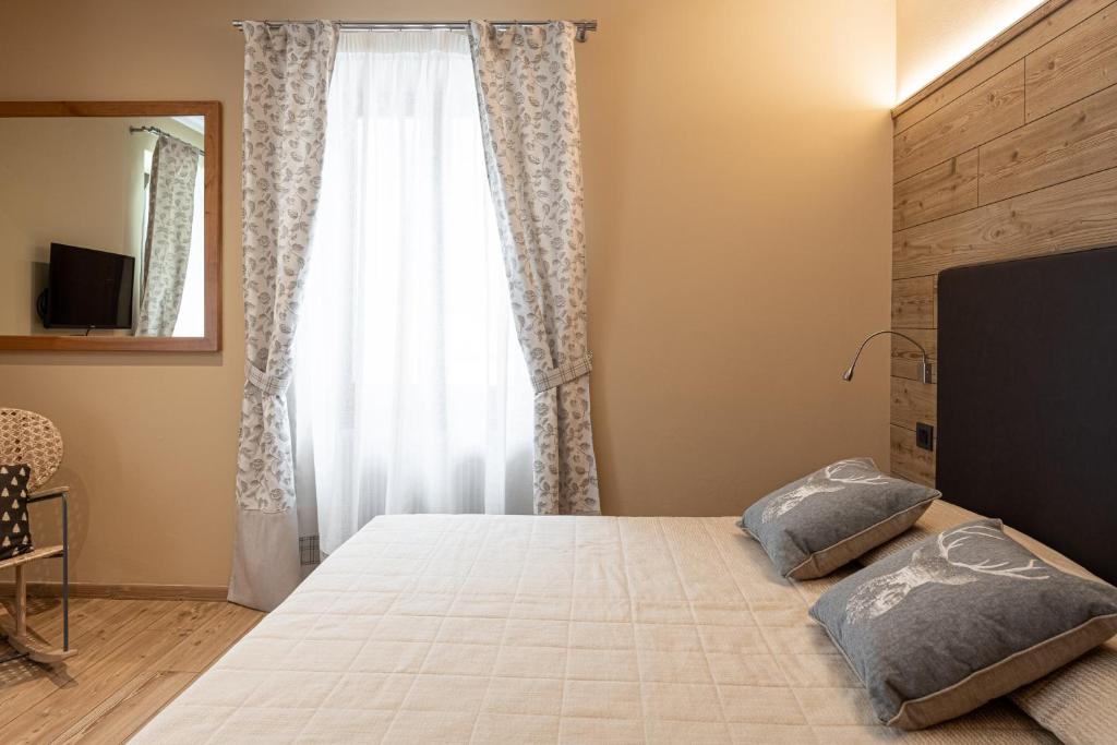 Postel nebo postele na pokoji v ubytování Hotel Pangrazzi - 3 stelle superior