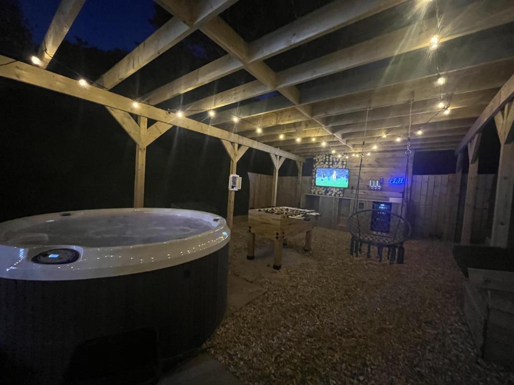 a room with a bath tub in a room with a table at Cariad in Tenby