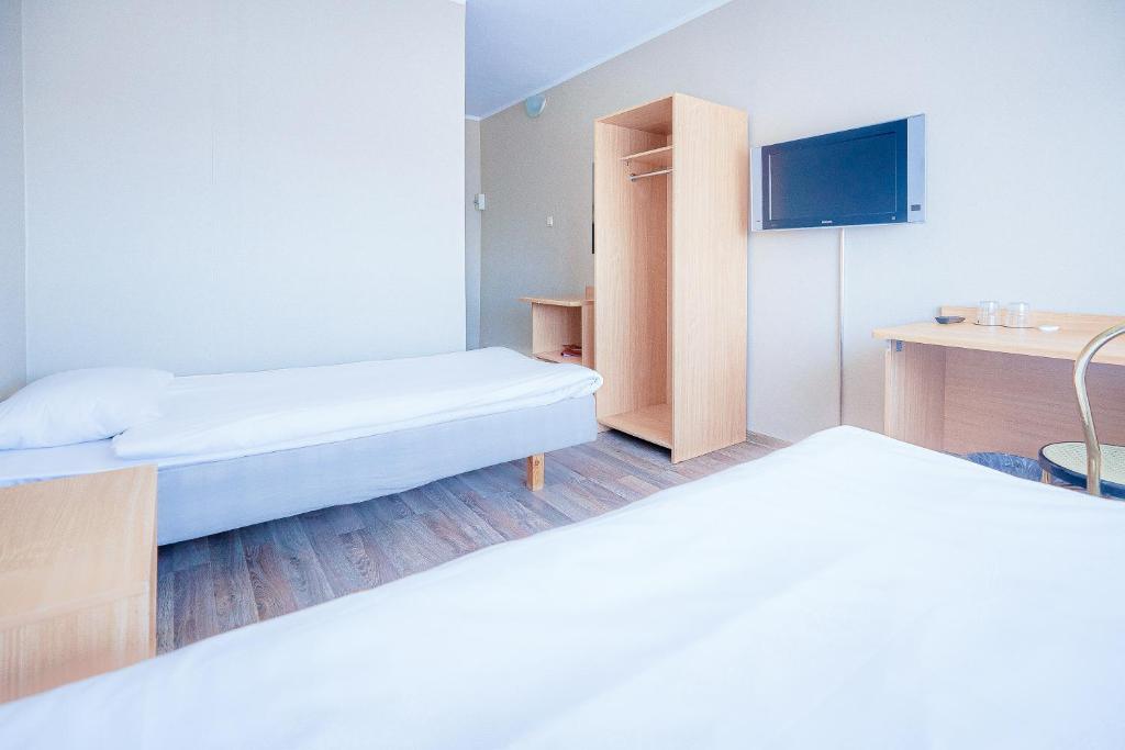 Postel nebo postele na pokoji v ubytování Hotel Dzingel